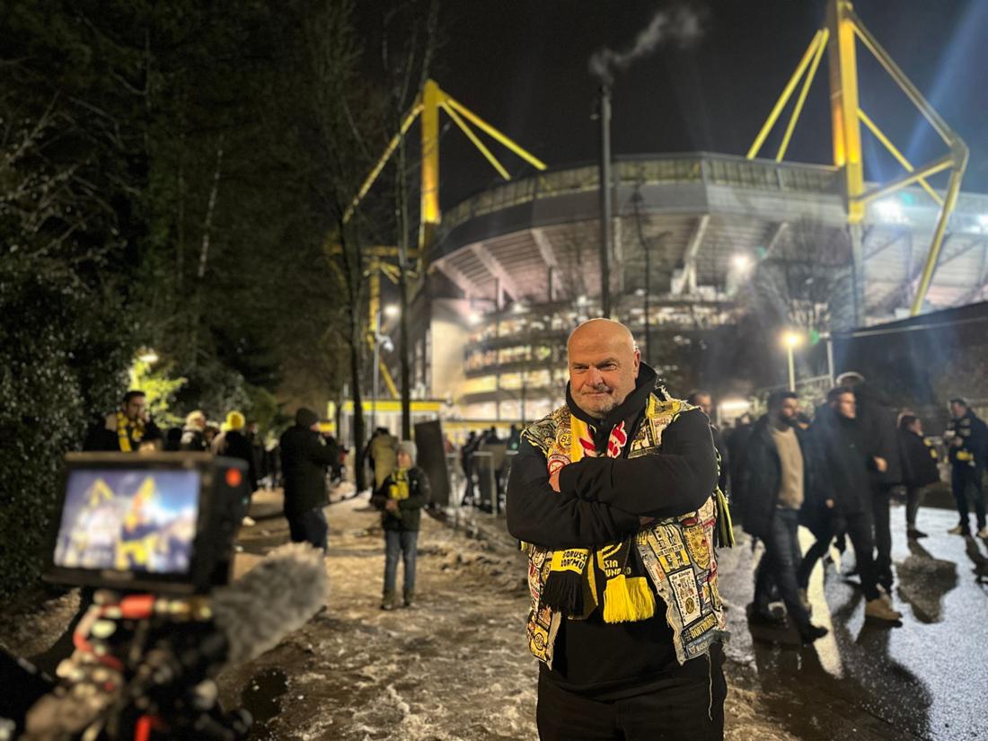 A Borussia Dortmund fan outside the stadium on match night with the camera in front of him