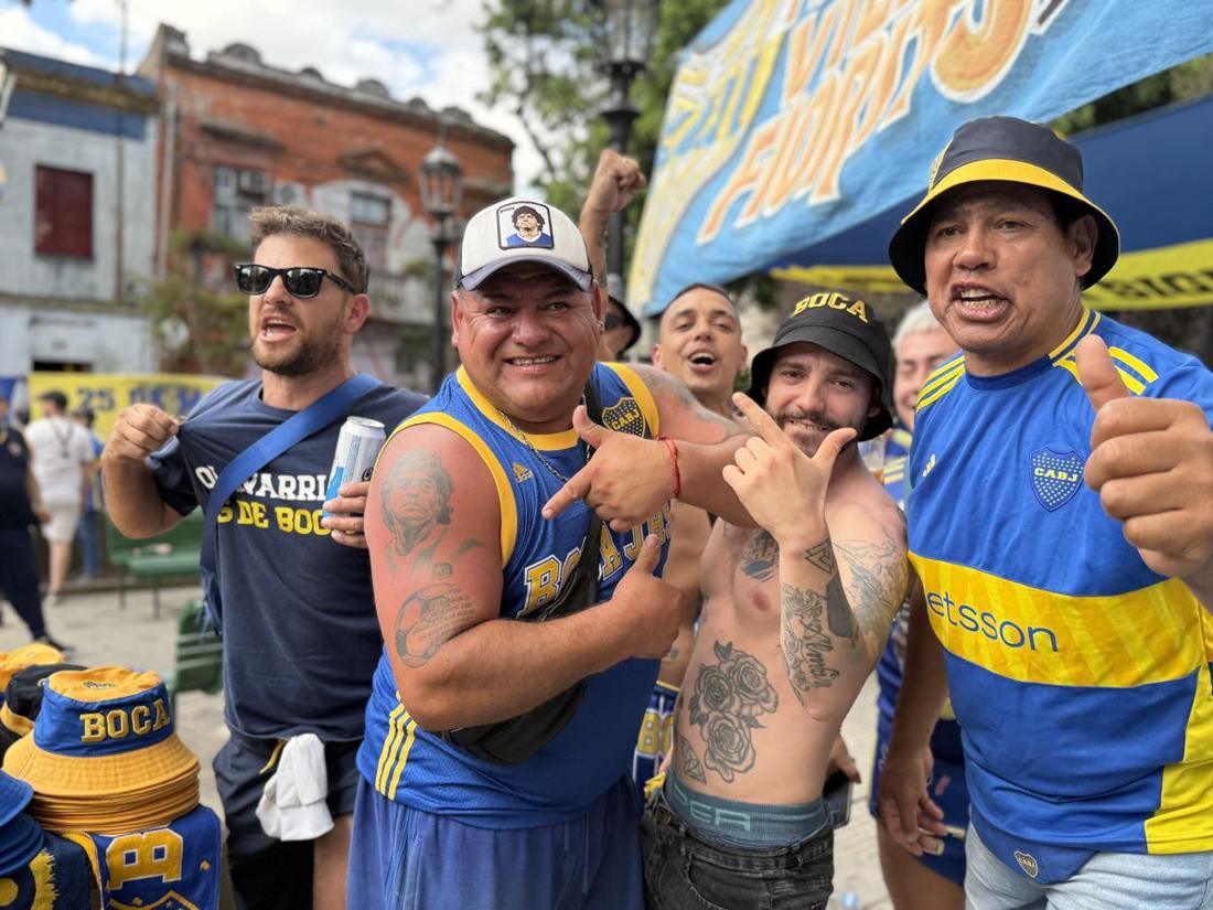 Boca Juniors fans posing for the camera outside the stadium